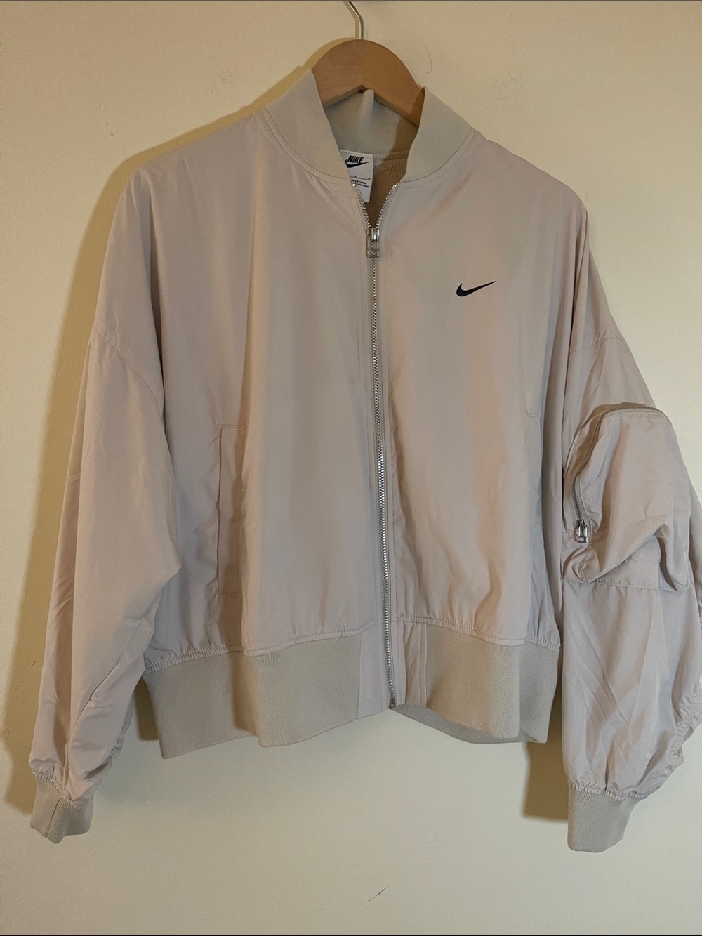 Nike Women's Beige Bomber Jacket with Swoosh with arm pocket. Ruched back size M